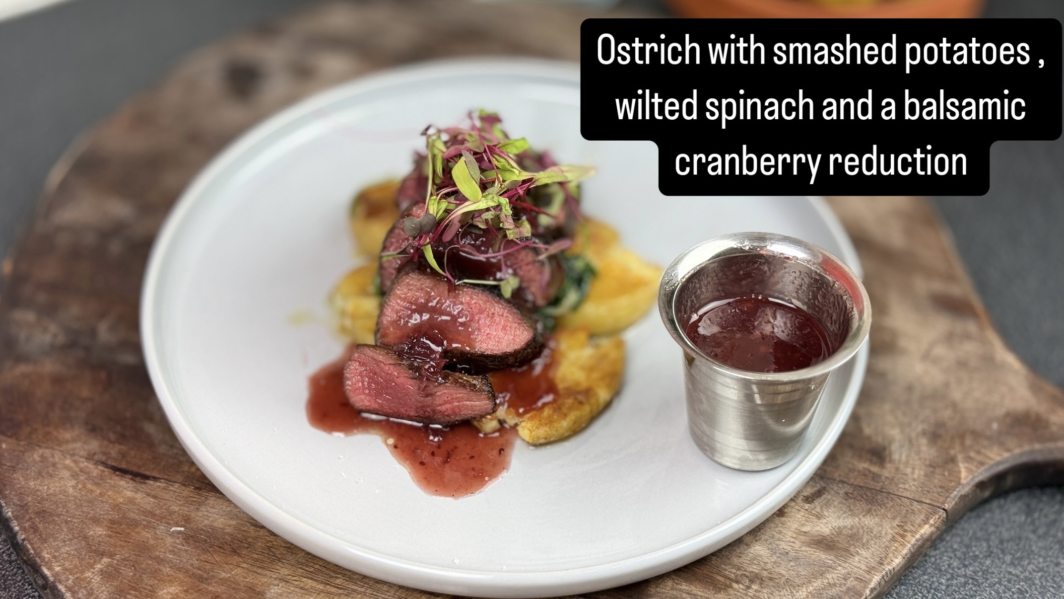 Ostrch fillet , smashed potatoes , wilted spinach with balsamic cranberry reduction